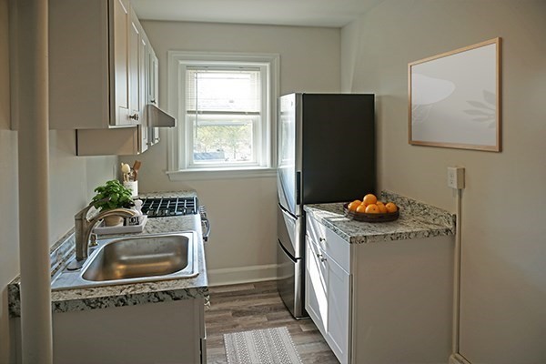 95 Adams Street, Unit 9 Waltham, MA 02453 - Photo 2 of 8 a bathroom with a sink mirror vanity and window