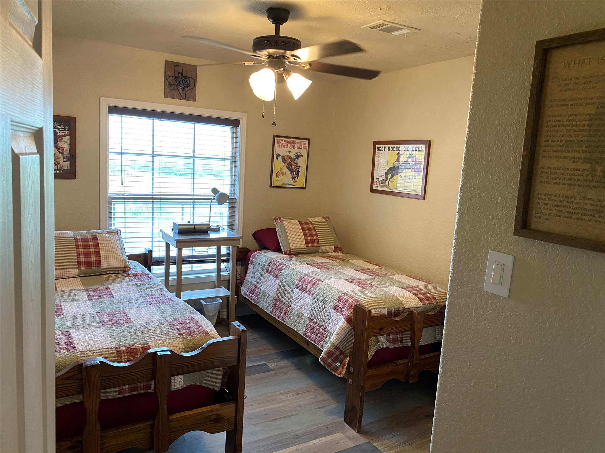 906 C R 235 Old Glory, TX 79540 - Photo 32 of 40 Bedroom featuring wood finished floors, a textured wall, and a ceiling fan