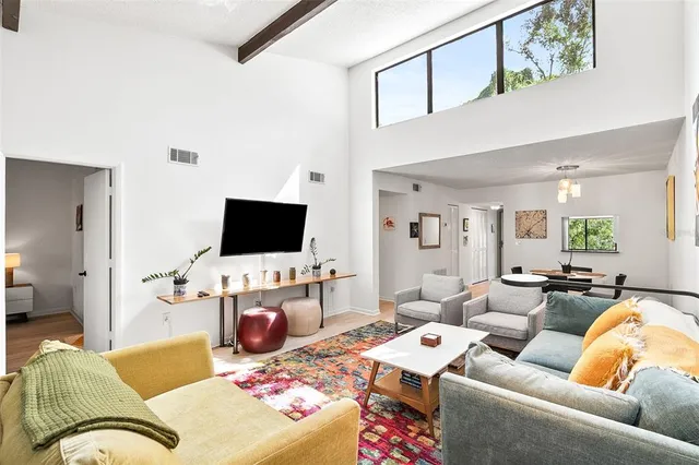 a bedroom with a bed and painting on the wall