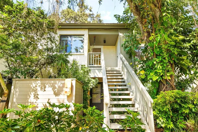 a hallway with a couch and a dining table next to a window