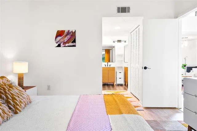 a bedroom with a bed and a large window