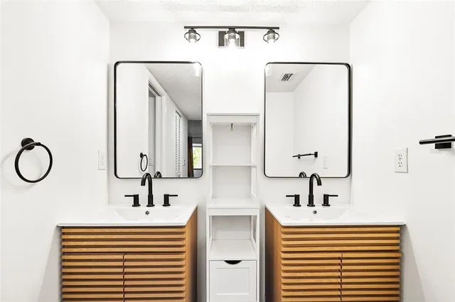 a bathroom with a sink a toilet and shower curtain