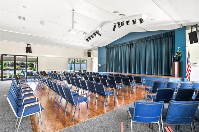a balcony with wooden floor and outdoor seating