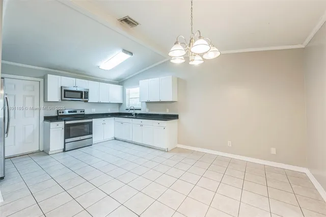 a large kitchen with cabinets and stainless steel appliances