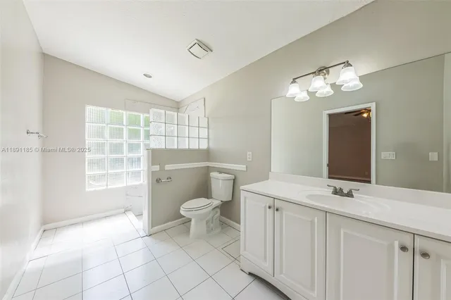 a bathroom with a toilet sink and a mirror