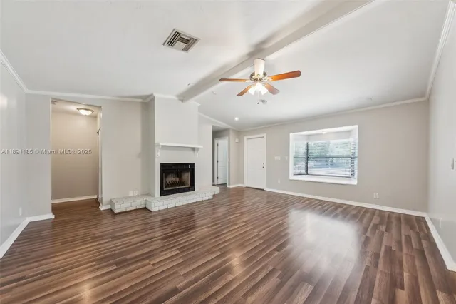 wooden floor in an empty room with a fireplace