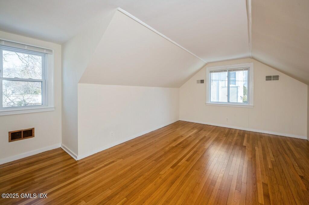 19 Bayside Terrace Riverside, CT 06878 - Photo 12 of 26 an empty room with wooden floor and windows