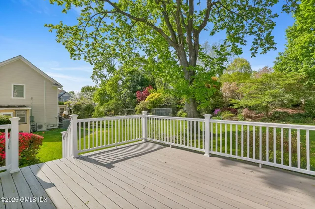 a view of backyard with deck and wooden floor