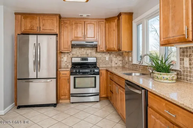 a kitchen with a refrigerator and white cabinets