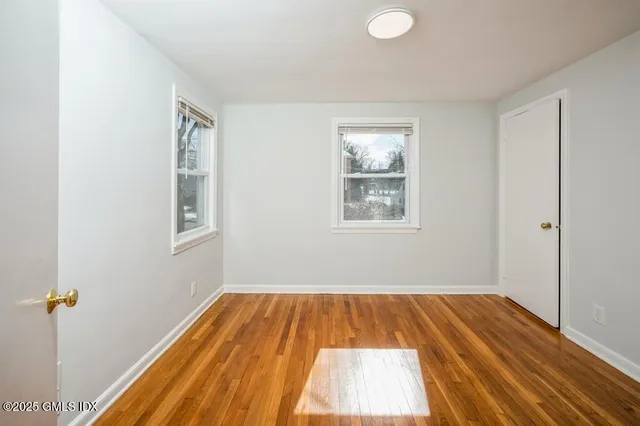 a view of a room with wooden floor and window