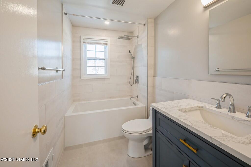 19 Bayside Terrace Riverside, CT 06878 - Photo 10 of 26 a bathroom with a granite countertop bathtub shower sink vanity mirror and toilet