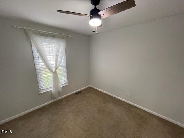4804 Hoyle Drive, Unit A Raleigh, NC 27604 - Photo 13 of 19 an empty room with a window and a fan