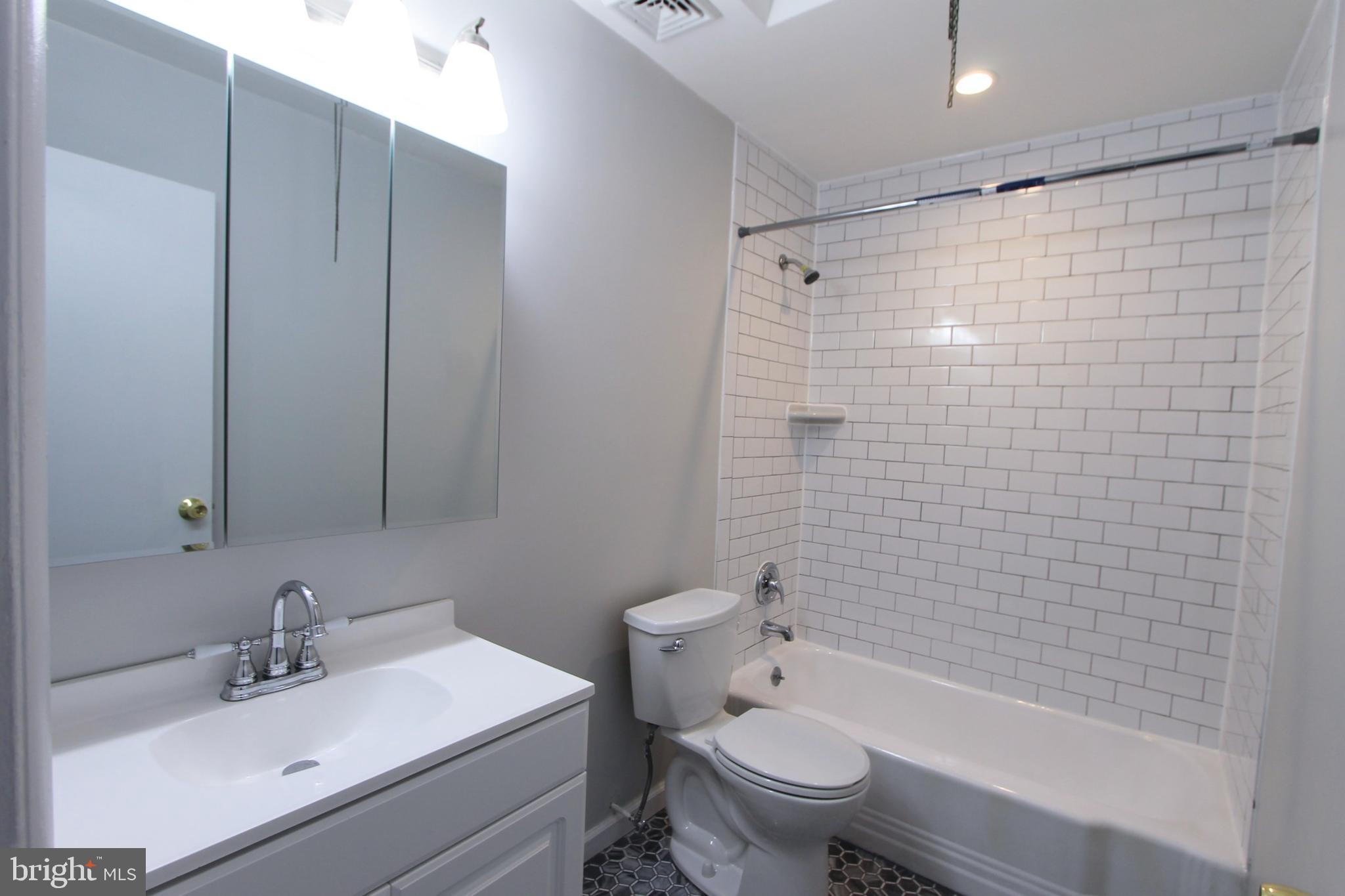 8613 Gilbert Street Philadelphia, PA 19150 - Photo 13 of 28 a bathroom with a sink toilet and shower