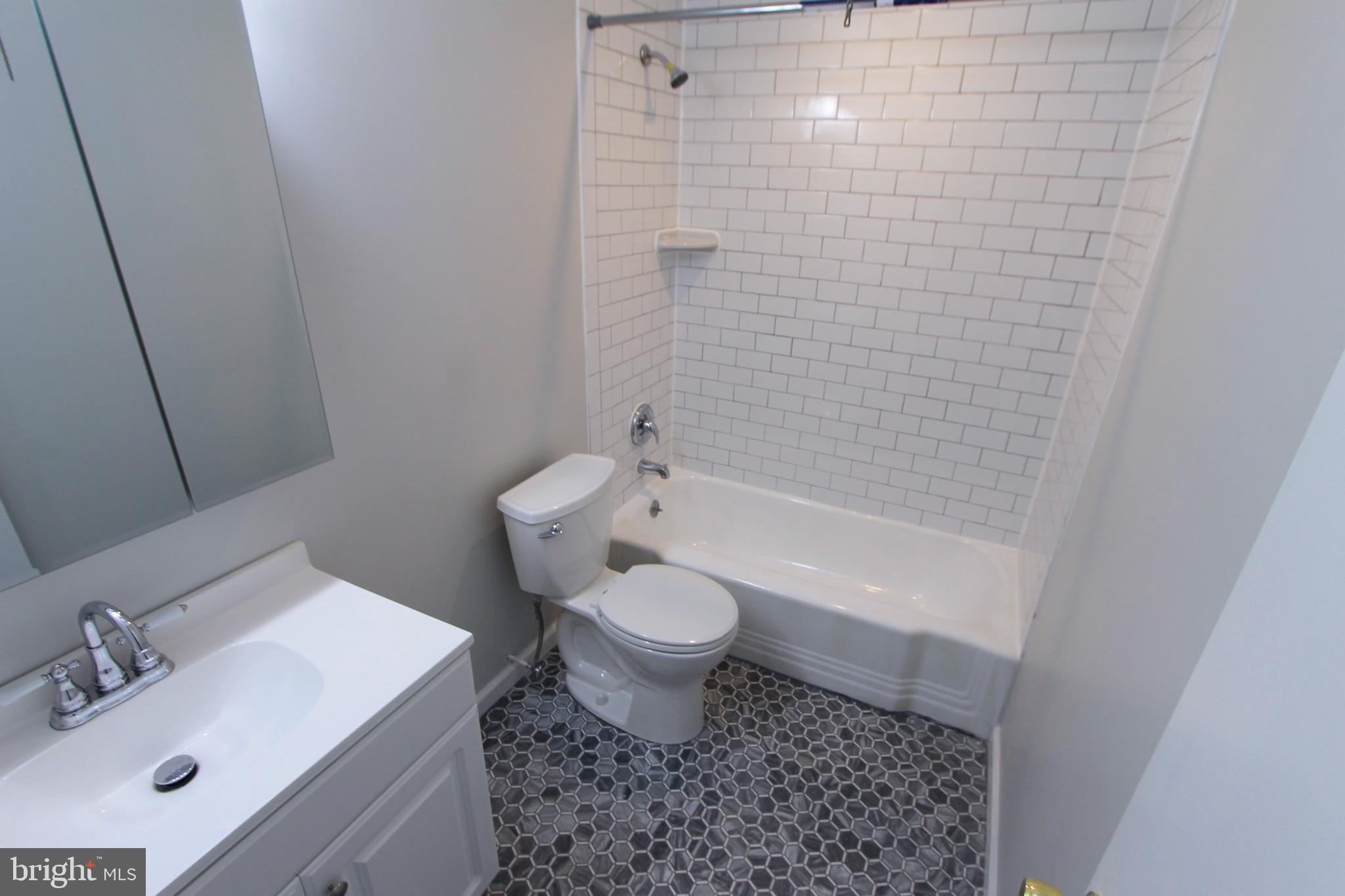8613 Gilbert Street Philadelphia, PA 19150 - Photo 14 of 28 a bathroom with a sink toilet and shower