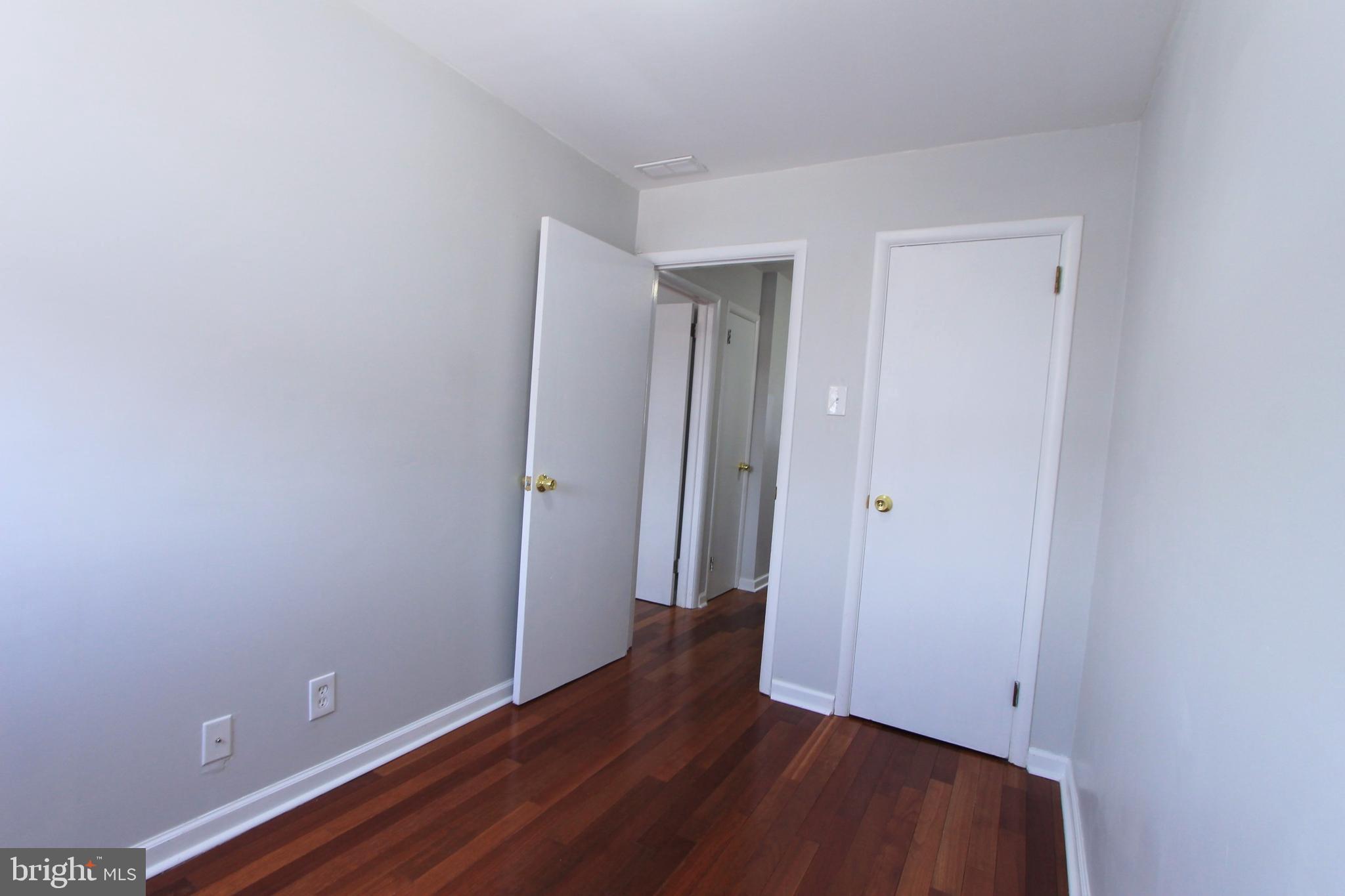 8613 Gilbert Street Philadelphia, PA 19150 - Photo 15 of 28 a view of an empty room with wooden floor