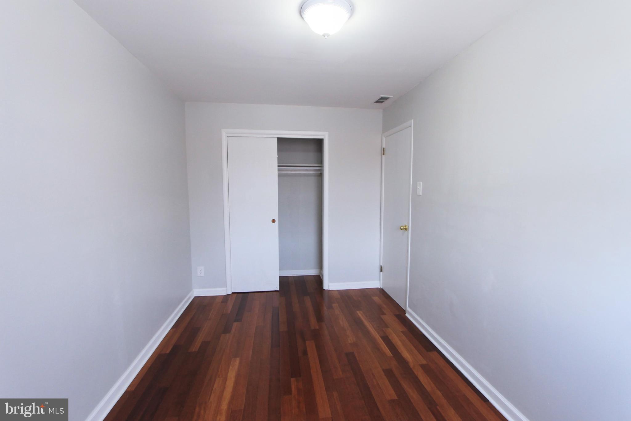 8613 Gilbert Street Philadelphia, PA 19150 - Photo 16 of 28 a view of a room with wooden floor and white walls