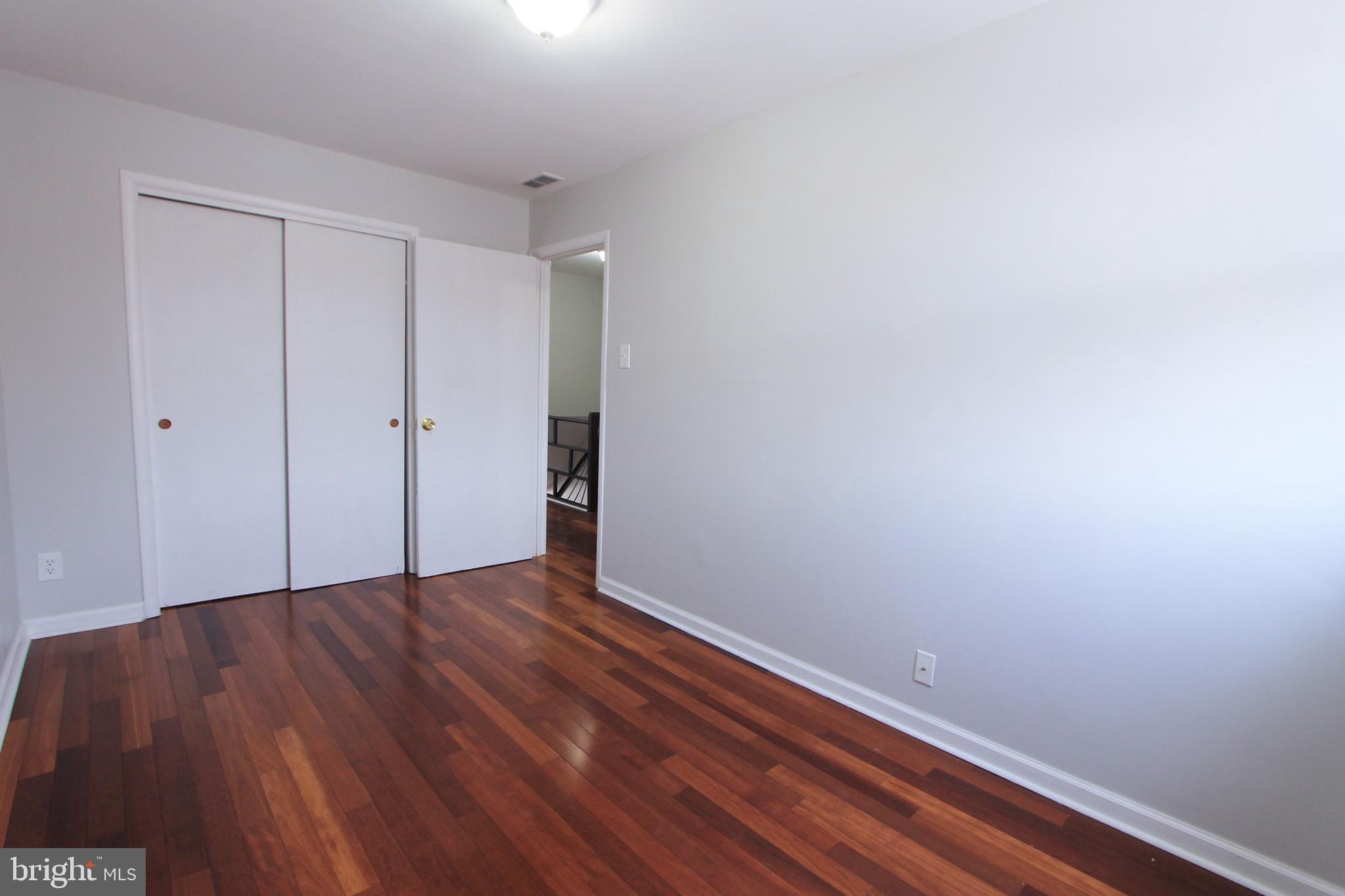 8613 Gilbert Street Philadelphia, PA 19150 - Photo 17 of 28 a view of an empty room with wooden floor