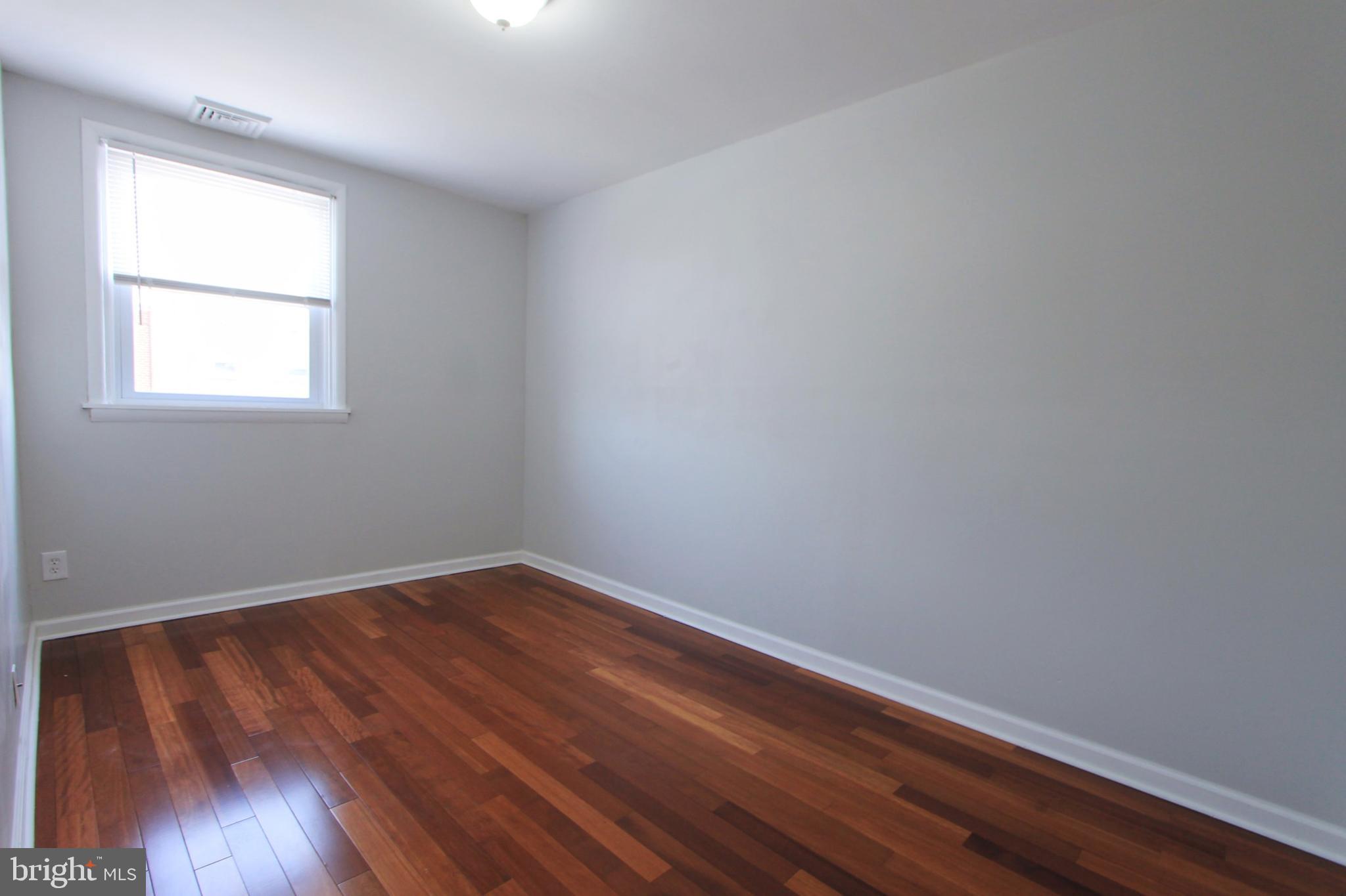 8613 Gilbert Street Philadelphia, PA 19150 - Photo 18 of 28 an empty room with wooden floor and windows