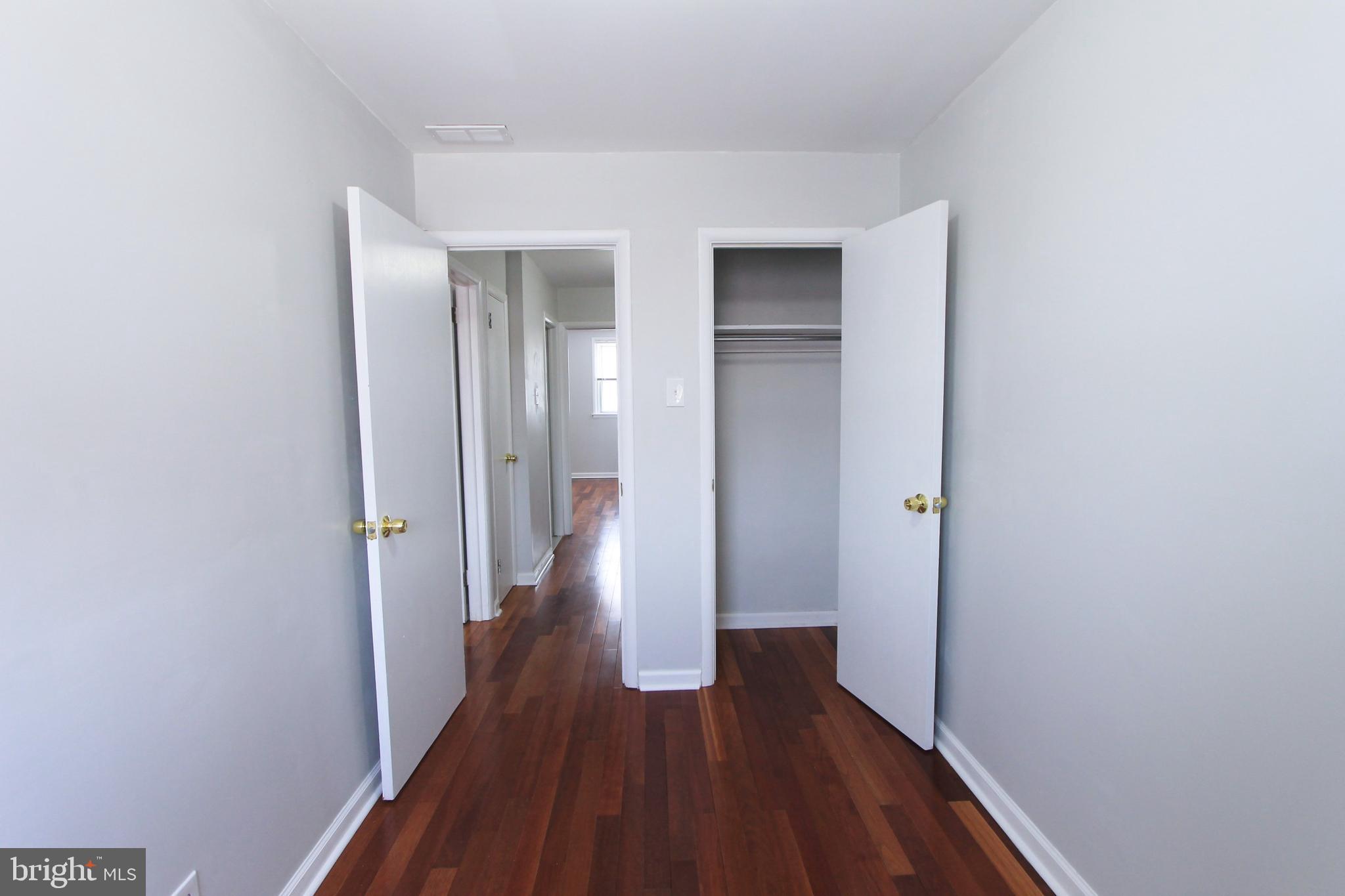 8613 Gilbert Street Philadelphia, PA 19150 - Photo 19 of 28 a view of a hallway with wooden floor