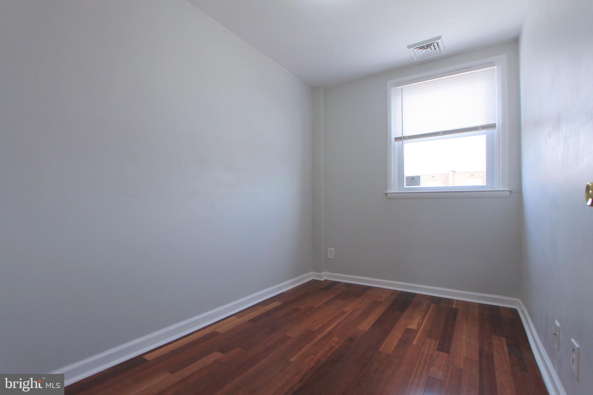 8613 Gilbert Street Philadelphia, PA 19150 - Photo 20 of 28 an empty room with wooden floor and windows