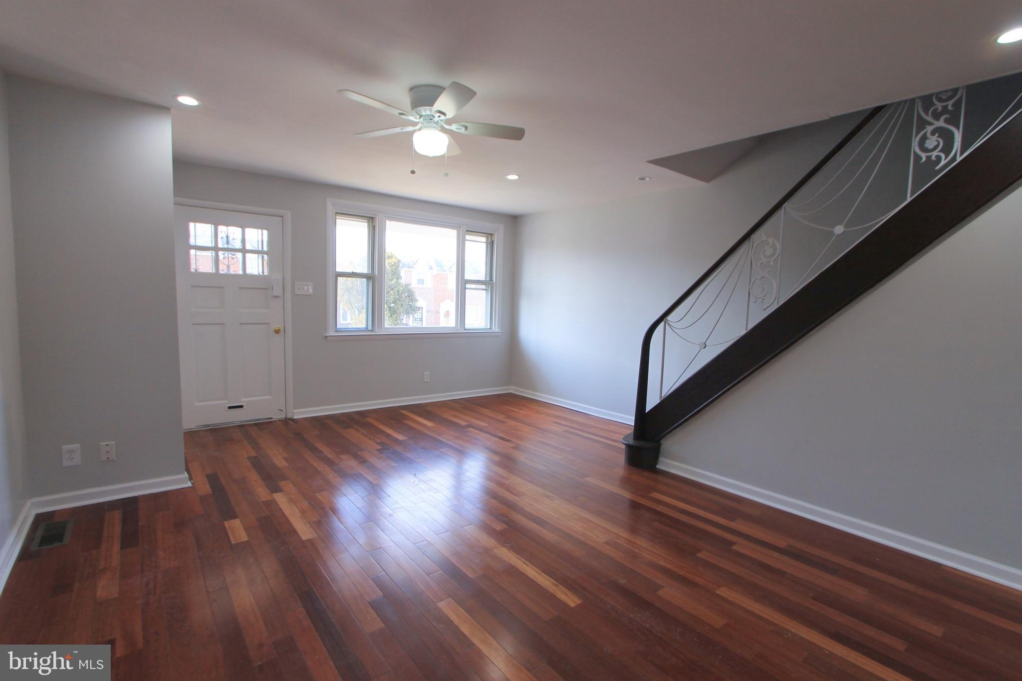 8613 Gilbert Street Philadelphia, PA 19150 - Photo 2 of 28 a view of an empty room with wooden floor and a window