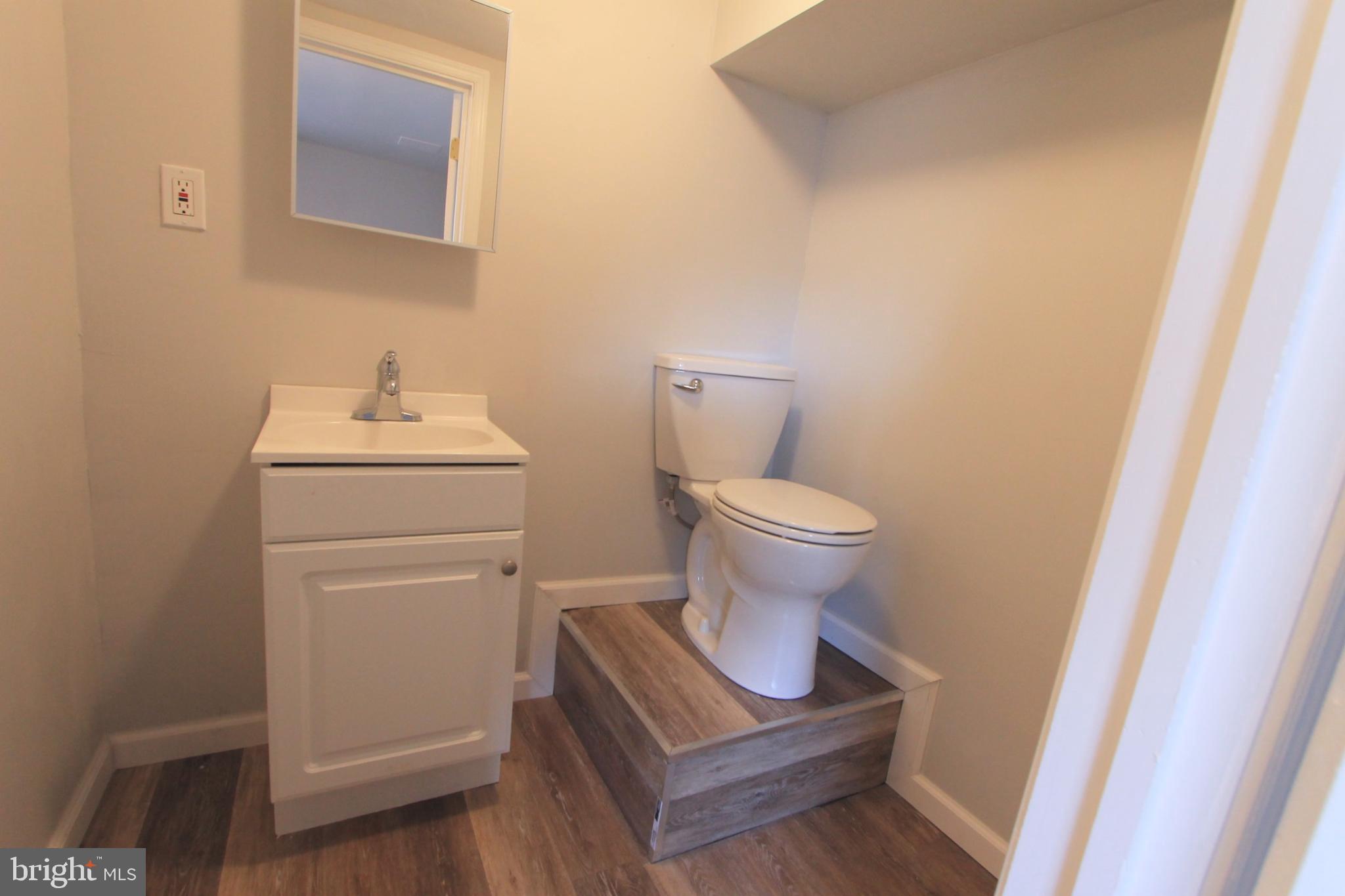 8613 Gilbert Street Philadelphia, PA 19150 - Photo 22 of 28 a bathroom with a sink toilet and vanity