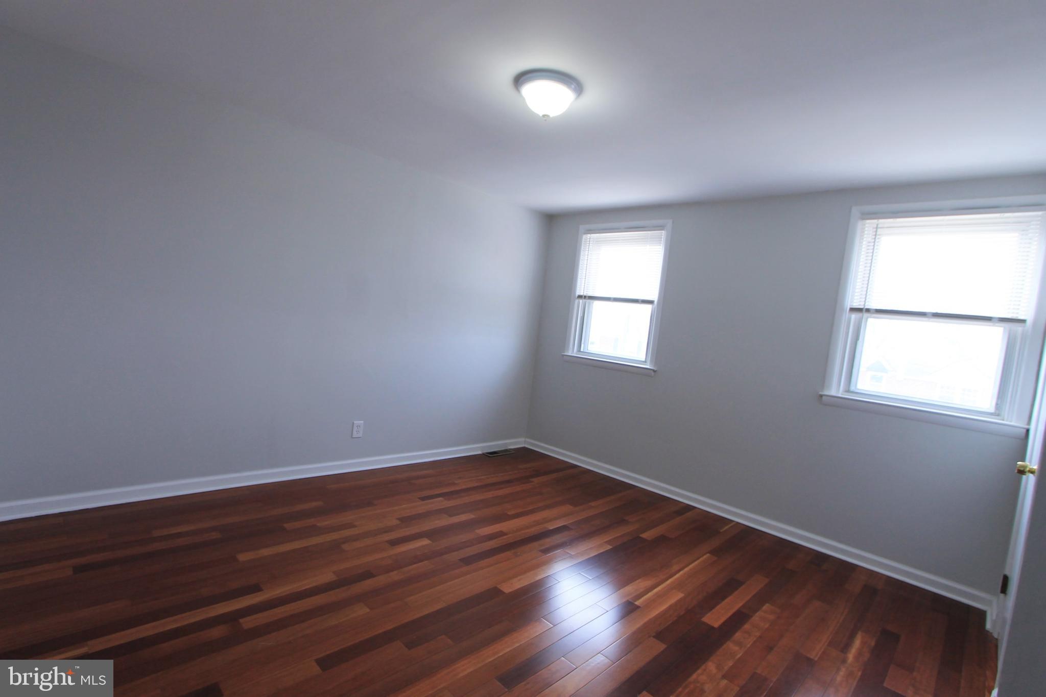 8613 Gilbert Street Philadelphia, PA 19150 - Photo 24 of 28 a view of an empty room with wooden floor and a window