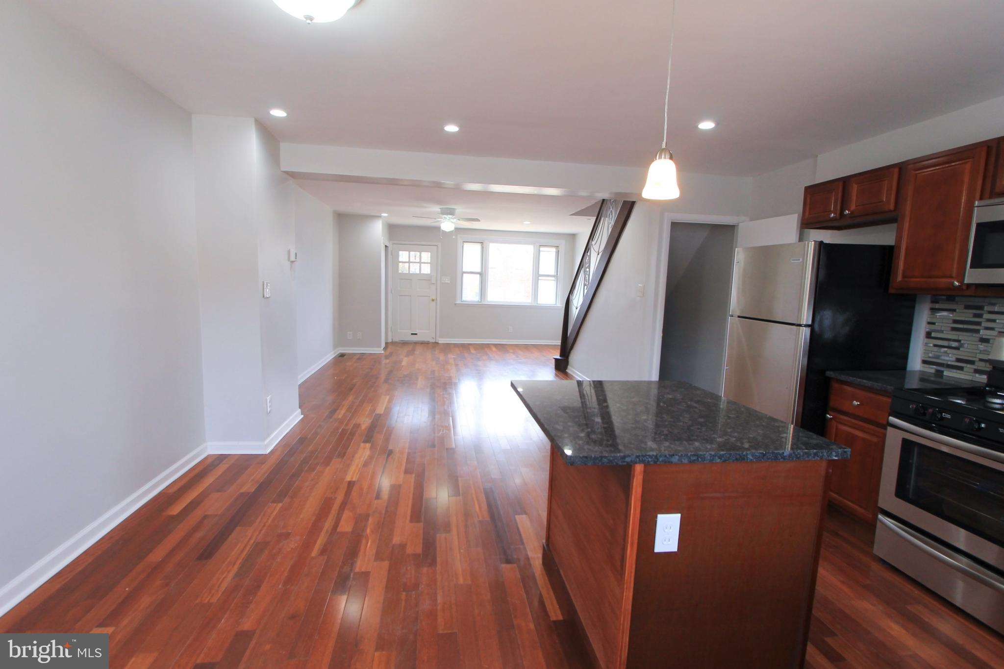 8613 Gilbert Street Philadelphia, PA 19150 - Photo 5 of 28 a view of kitchen with cabinets and wooden floor