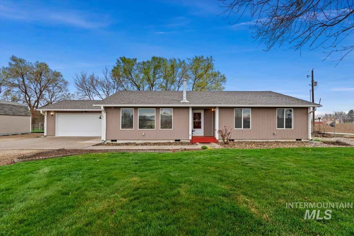 1051 Haas Road Weiser, ID 83672 - Photo 1 of 44 Ranch-style home with crawl space, roof with shingles, driveway, and a front yard
