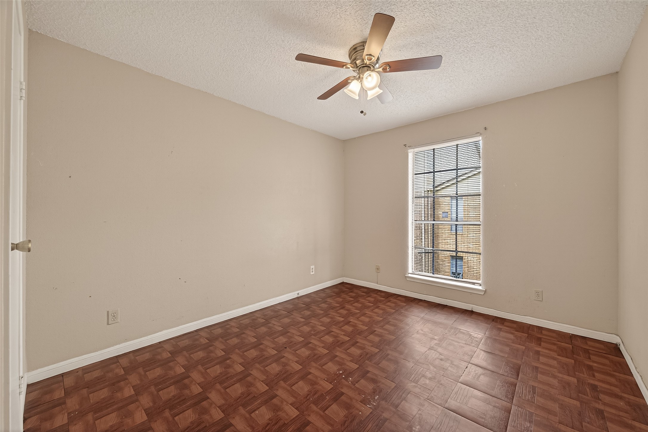 10101 South Gessner Road, Unit 307 Houston, TX 77071 - Photo 3 of 20 an empty room with windows and ceiling fan