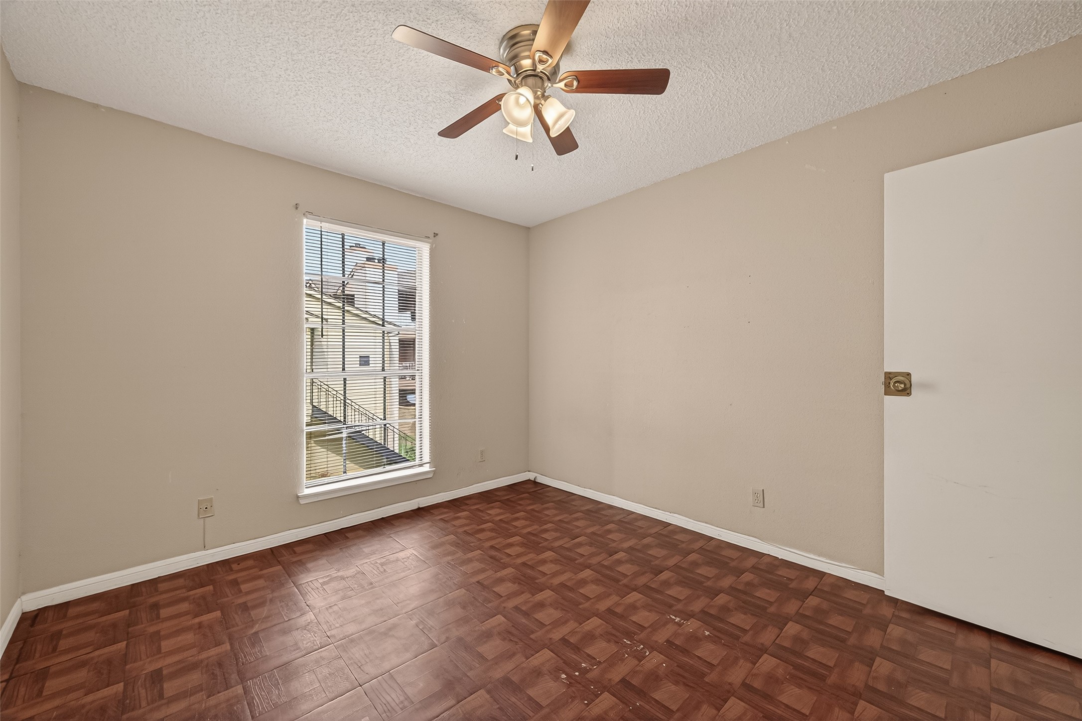 10101 South Gessner Road, Unit 307 Houston, TX 77071 - Photo 4 of 20 an empty room with windows and fan