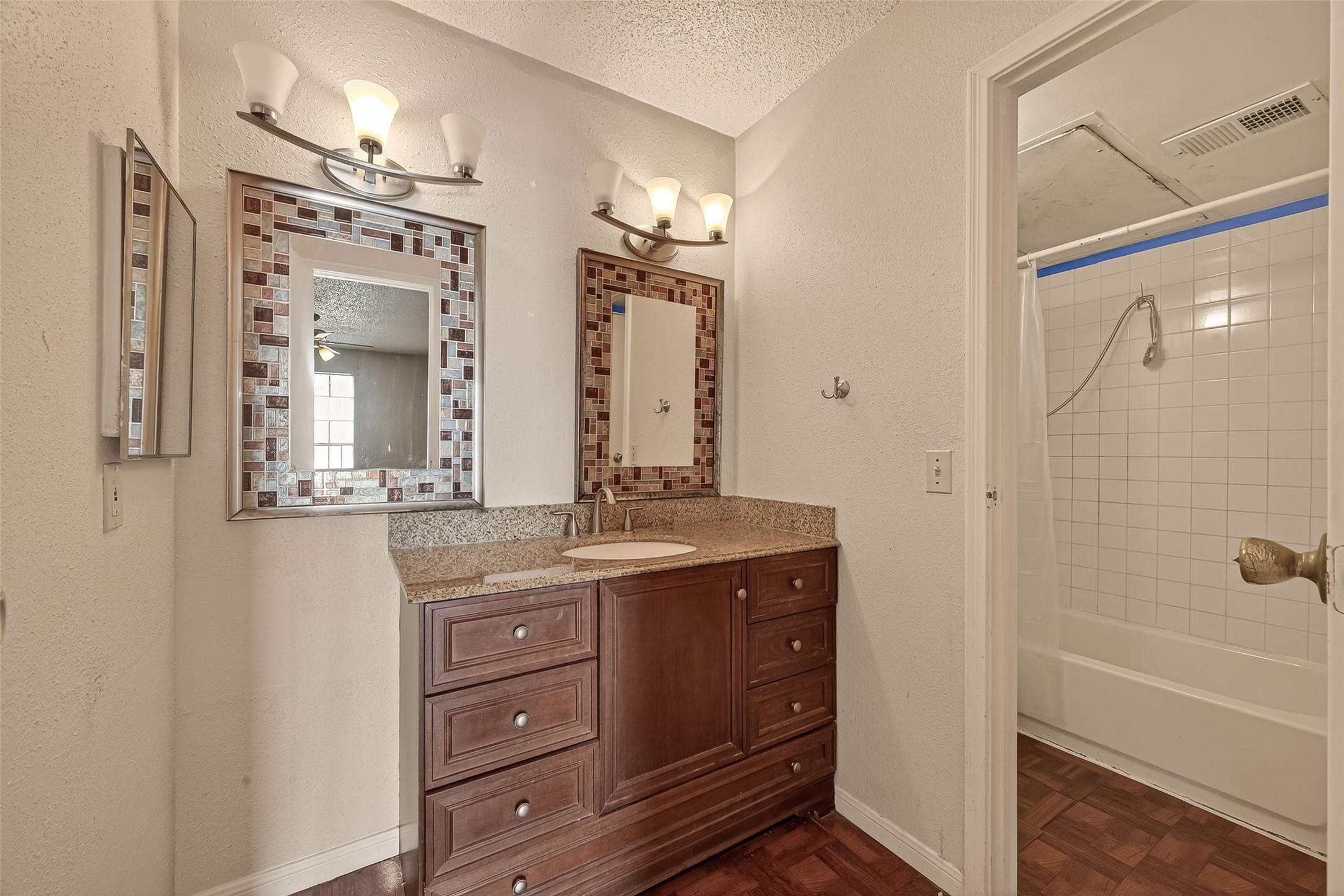 10101 South Gessner Road, Unit 307 Houston, TX 77071 - Photo 7 of 20 a bathroom with a granite countertop sink a mirror a vanity and a bathtub