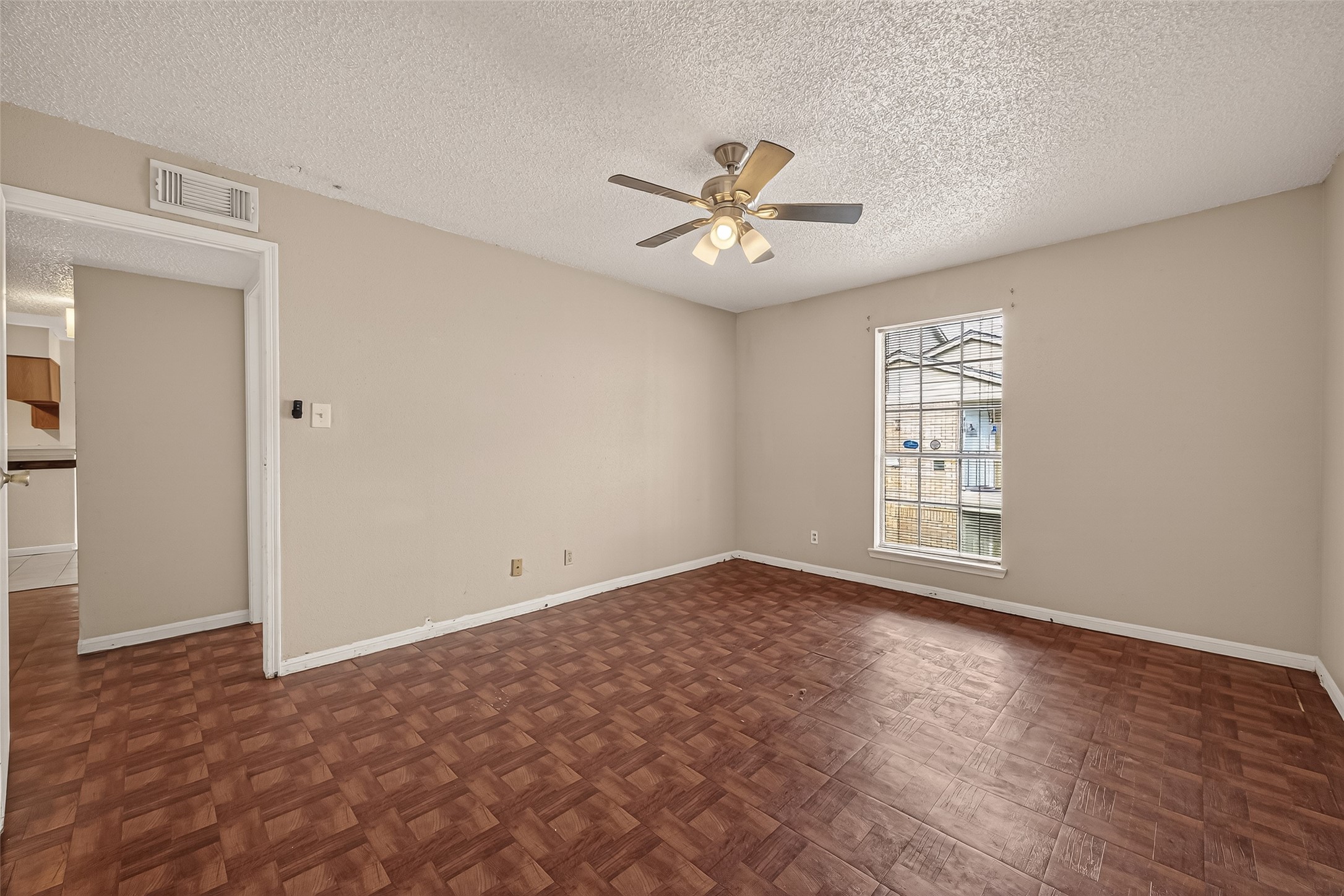 10101 South Gessner Road, Unit 307 Houston, TX 77071 - Photo 9 of 20 a view of empty room with wooden floor and fan