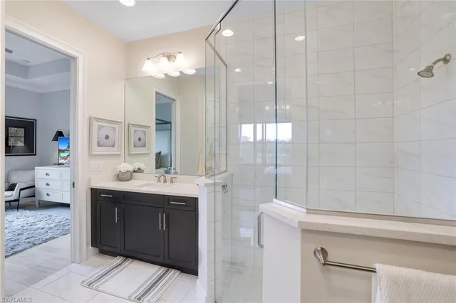 a bathroom with a double vanity sink mirror and shower