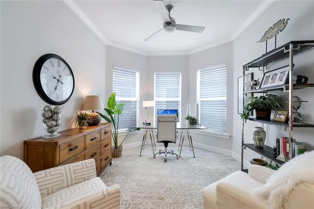 a living room with furniture a window and a flat screen tv