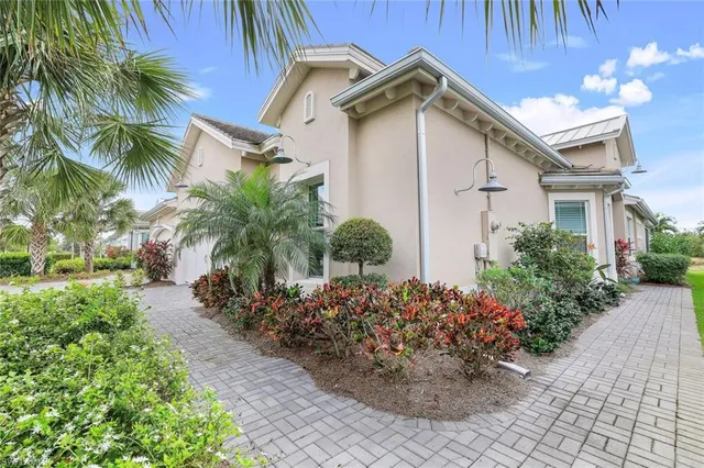 a white house with a small yard and a garden