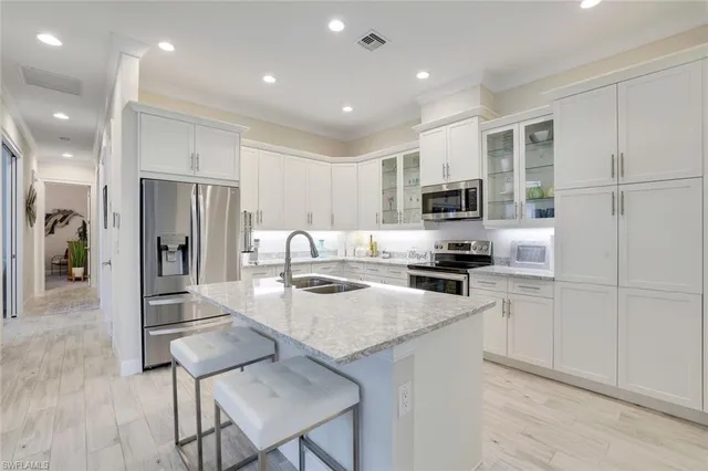 a kitchen with a refrigerator and a stove top oven