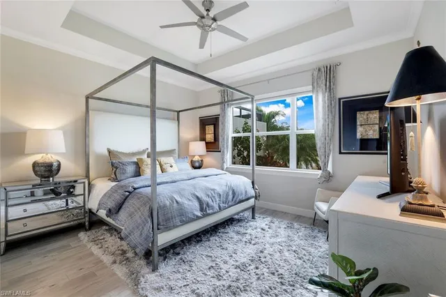 a bedroom with a bed window and a flat screen tv