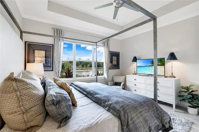 a bedroom with a bed and large windows