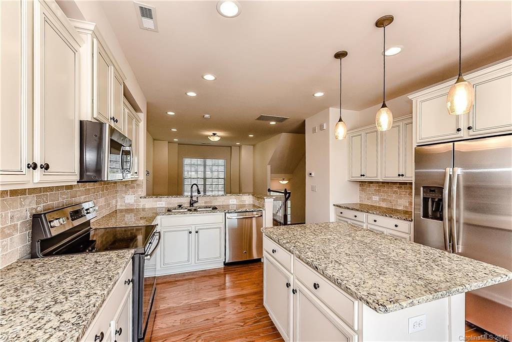 110 Layla Drive, Unit CC180 Tega Cay, SC 29708 - Photo 8 of 23 a kitchen with stainless steel appliances granite countertop a sink stove and refrigerator