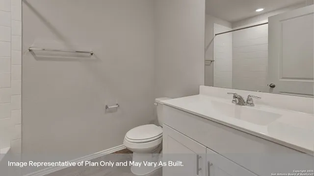 a bathroom with a toilet a sink and a mirror