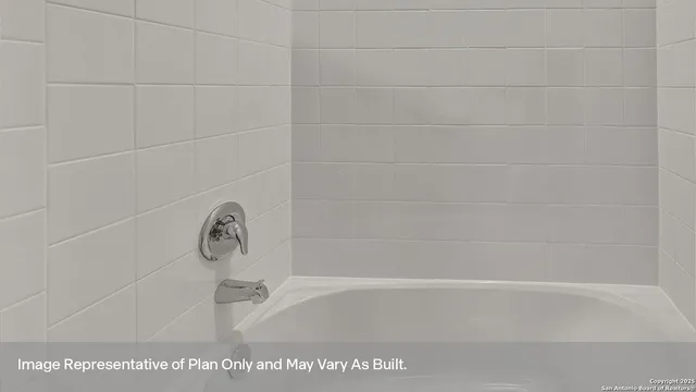 a bath tub sitting next to a white sink
