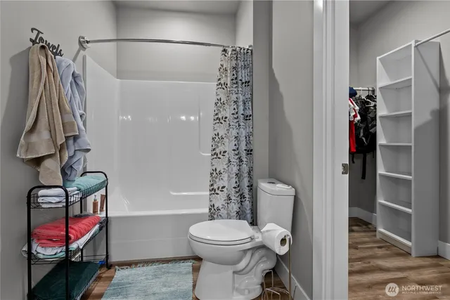 a bathroom with a toilet a sink and shower