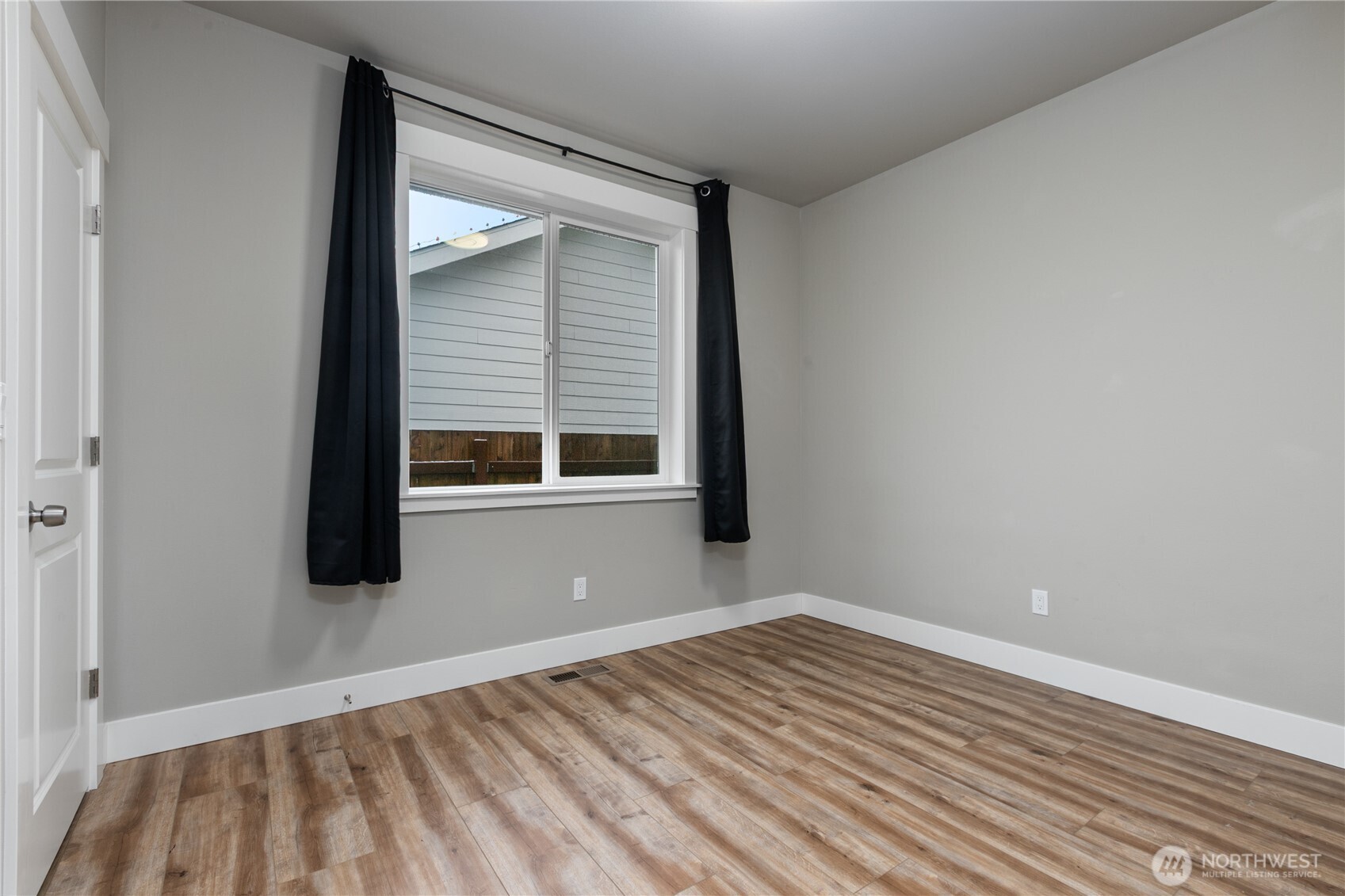 8233 Goldrun Drive Maple Falls, WA 98266 - Photo 16 of 24 a view of empty room with wooden floor and fan