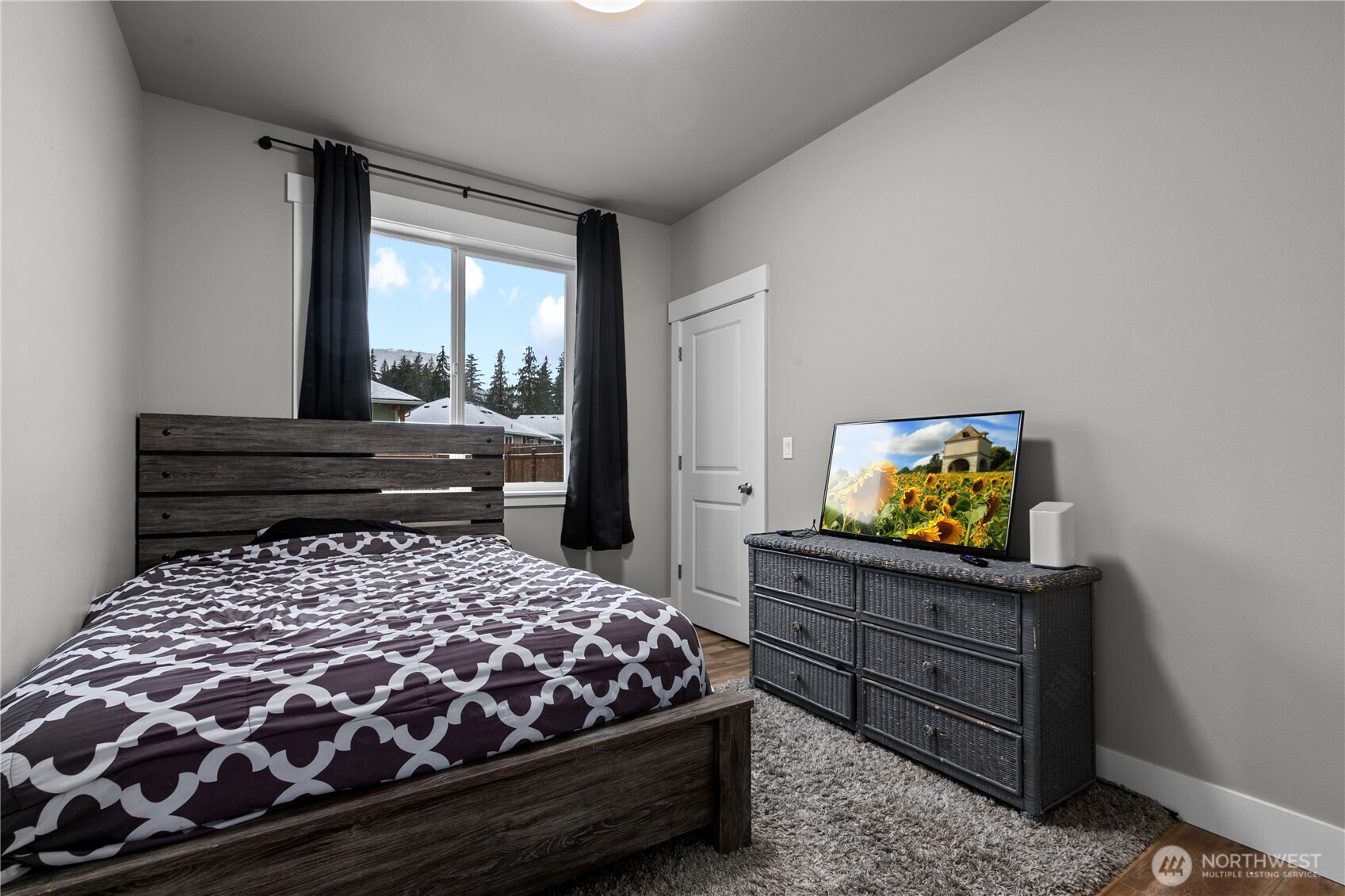 8233 Goldrun Drive Maple Falls, WA 98266 - Photo 17 of 24 a bedroom with a bed and flat tv screen on a dresser