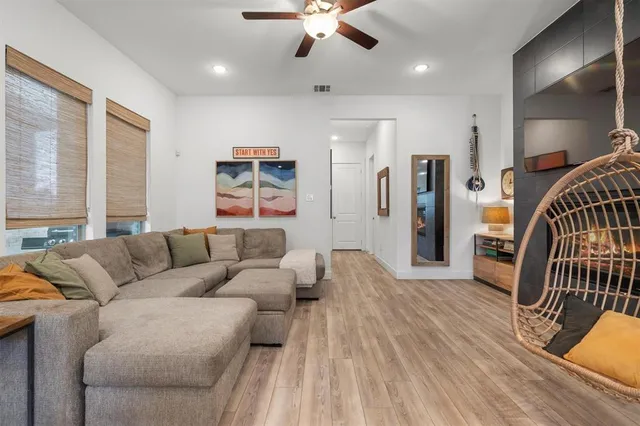 a living room with furniture and wooden floor