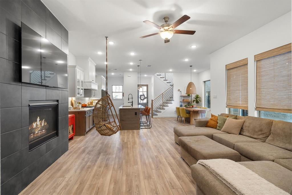 813 Forest Lake Road Flower Mound, TX 75028 - Photo 12 of 39 a living room with furniture kitchen view and a fireplace