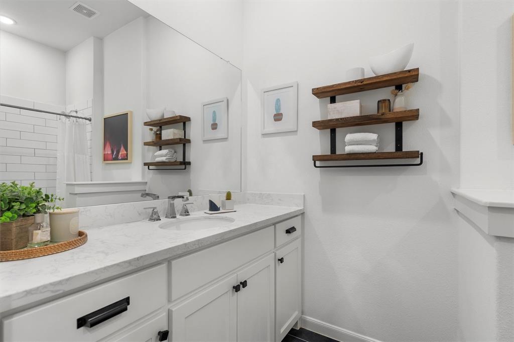 813 Forest Lake Road Flower Mound, TX 75028 - Photo 15 of 39 a bathroom with a sink and a mirror