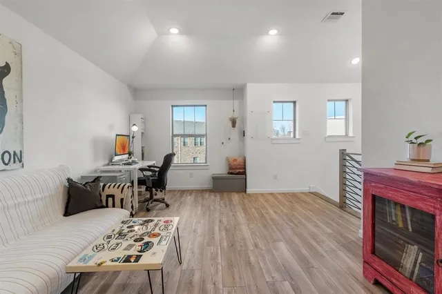 a bedroom with furniture and a wooden floor