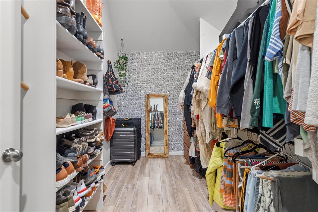 813 Forest Lake Road Flower Mound, TX 75028 - Photo 20 of 39 a view of walk in closet with clothes and shoes